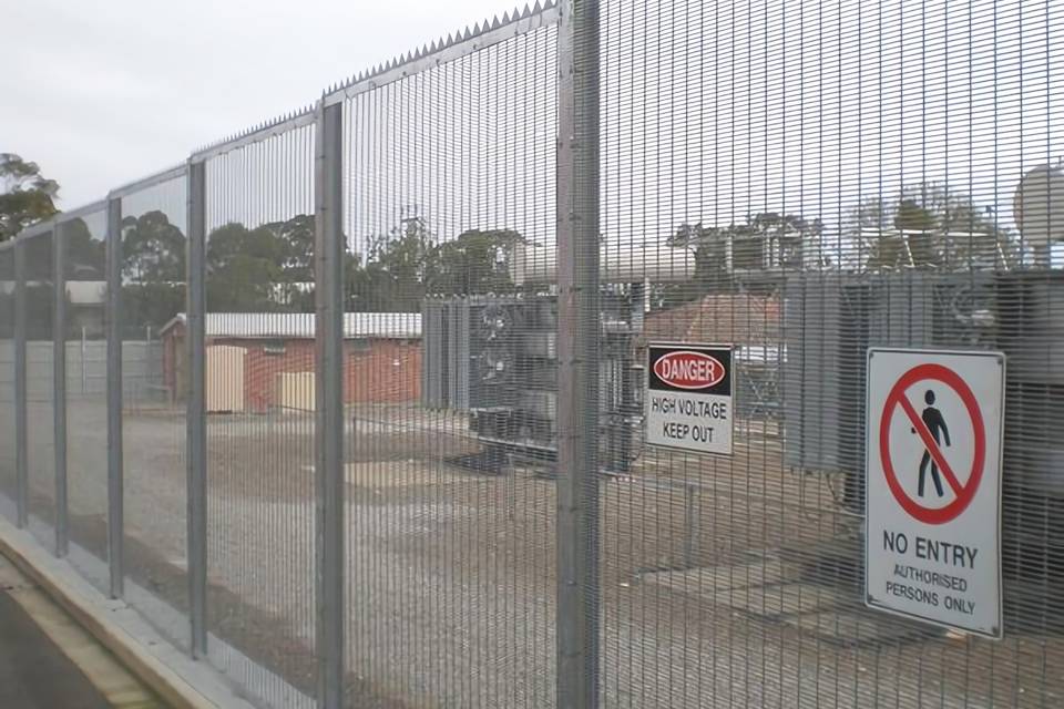 358 high security fence is equipped with spikes and two warning signs to protect electric installations there.