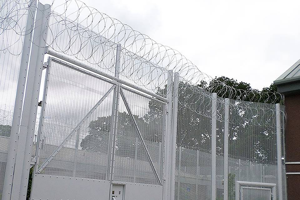 358 high security fence is equipped with a razor wire topping and serves as a prison fence gate.