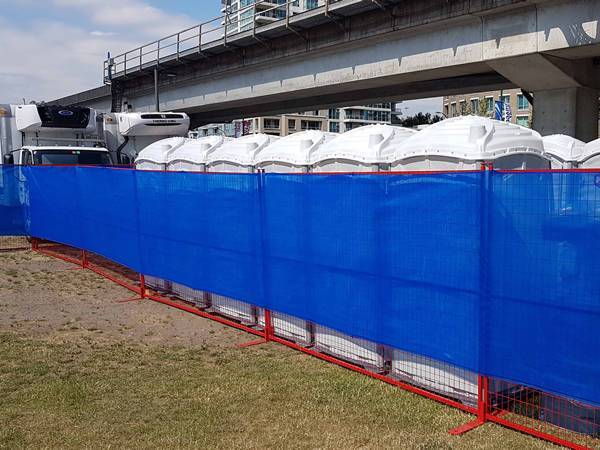 A piece of blue shade cloth works with Canada temporary fence to prevent dust blowing.