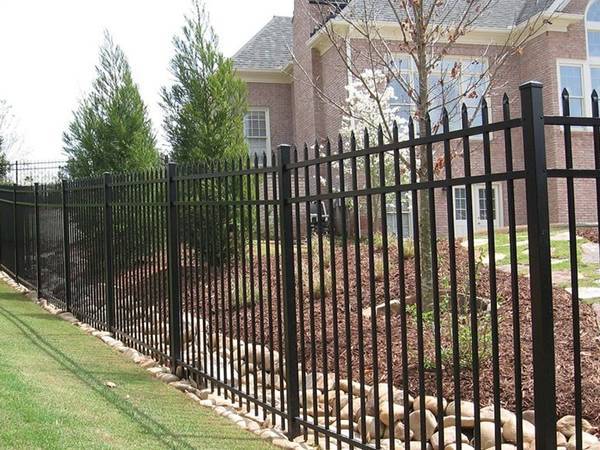A black powder coating is installed on the steel fence post
