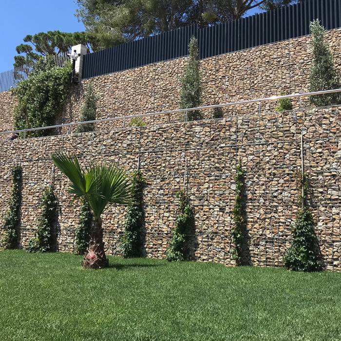 Welded gabions are installed as the exterior wall of the house.