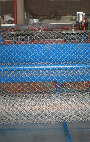 A weaving machine is producing chain link fence
